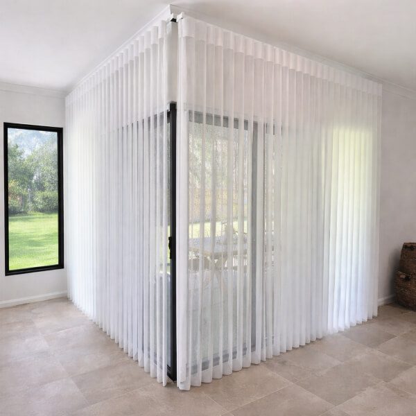 White Veri Shades wrapped around corner sliding doors, professionally installed by Blinds and Shutter Guys Newcastle.